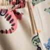 1,5-8 anos | Conjunto de camisola e calças de treino com estampado de dinossauros