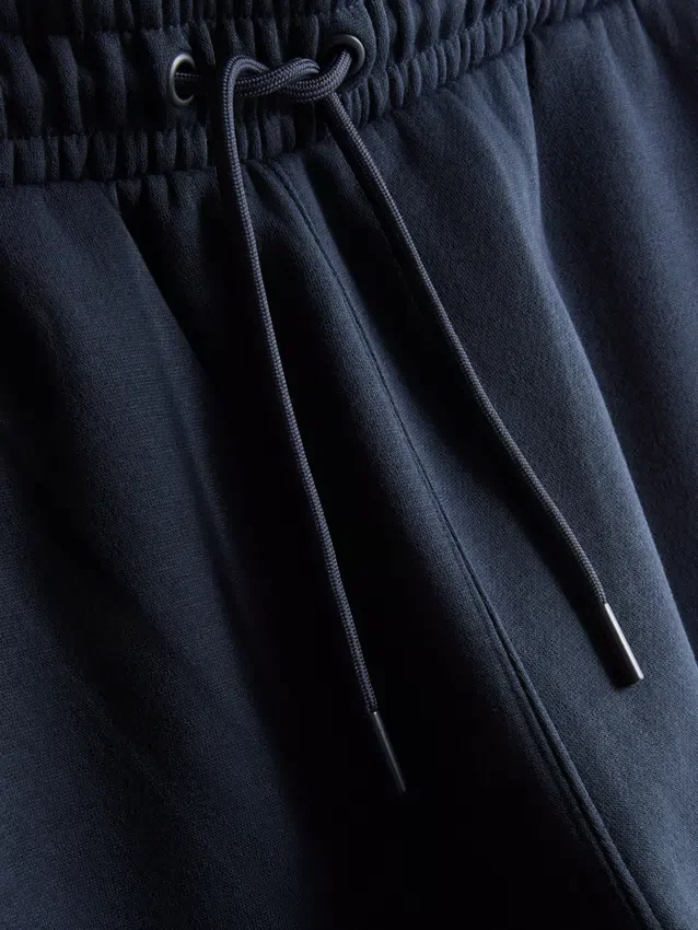 Calças de fato de treino com cintura elástica e bainhas com cordão