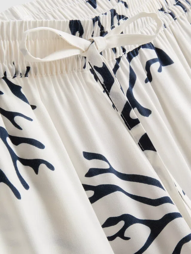 Calças de pijama de perna larga com estampado em tons de coral