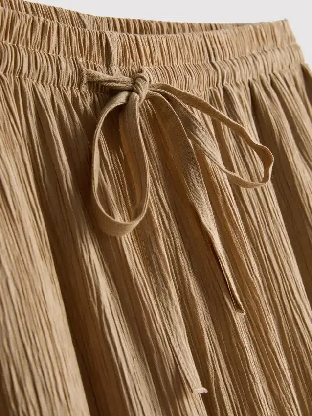 Calças largas com efeito enrugado