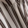 Camisa descontraída com botões e bainha curva