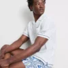 Camisas com gola reversível bordada com peixe