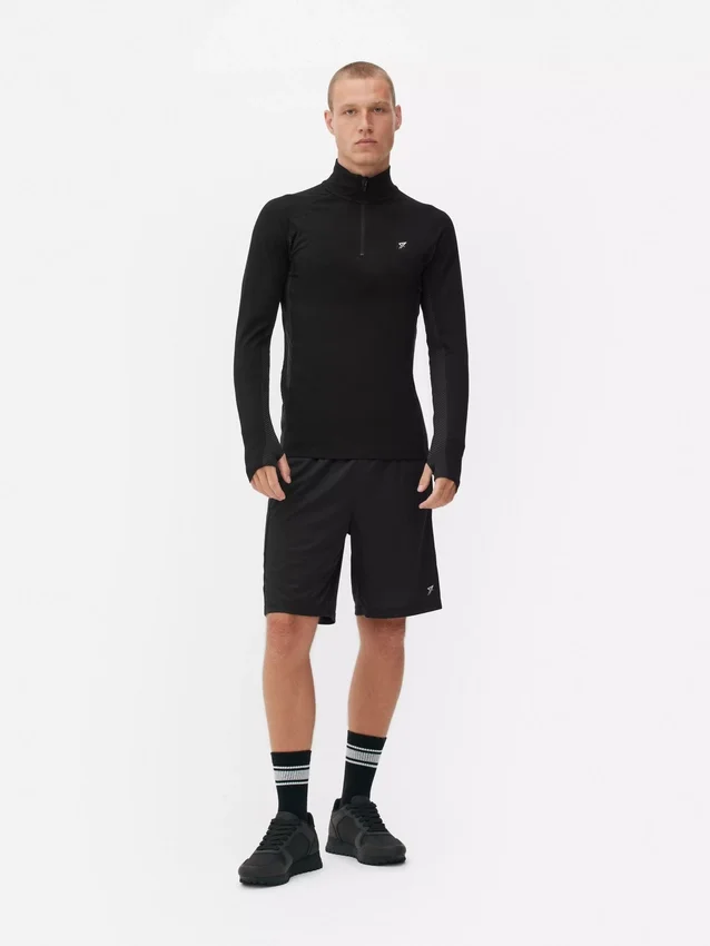 Camisola de treino de manga comprida com fecho de correr até um quarto