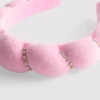 Fita para a cabeça almofadada e decorada